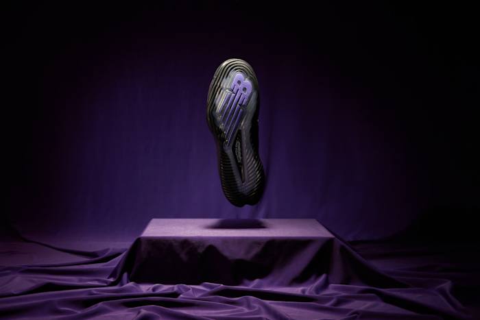 The outsole of Coco Gauff's black and purple New Balance tennis shoes.